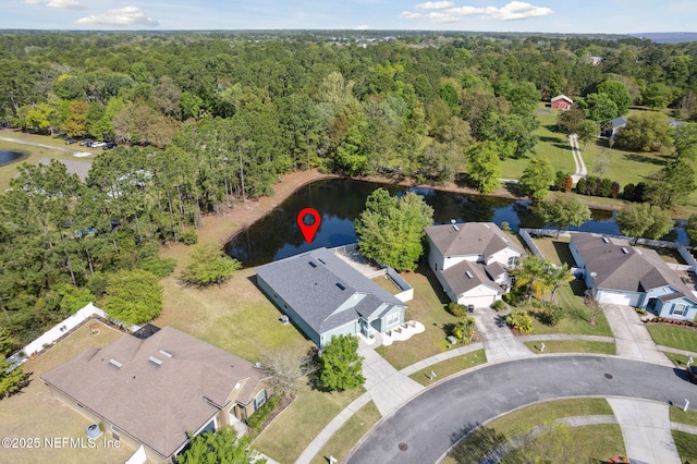 bird's eye view with a residential view, a view of trees, and a water view