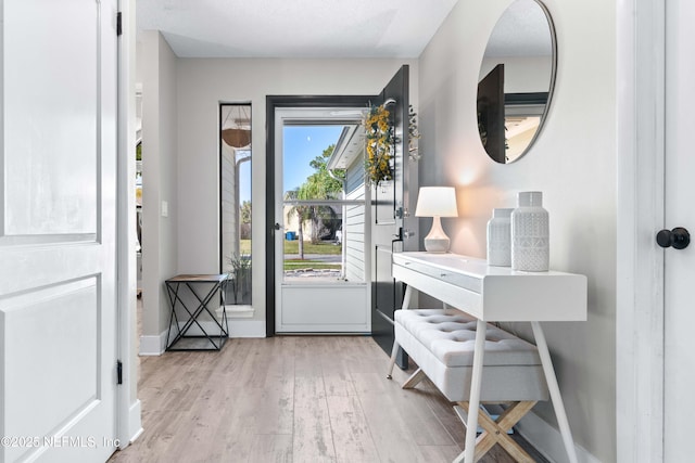 entryway featuring wood finished floors and baseboards