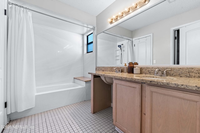 bathroom with double vanity, shower / bath combo with shower curtain, a sink, and tile patterned floors