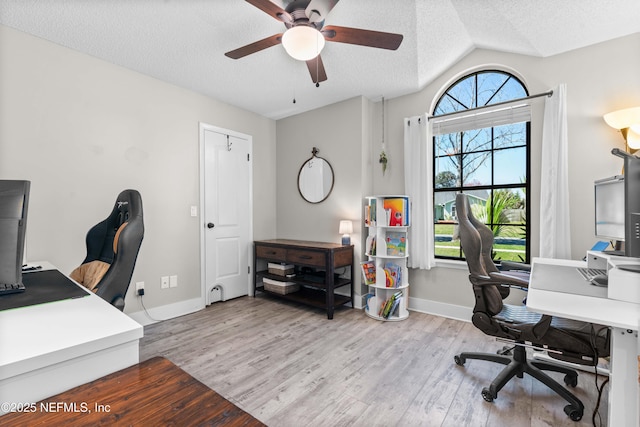 office space featuring a healthy amount of sunlight, a textured ceiling, and wood finished floors