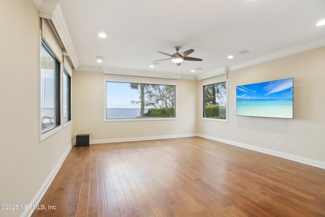 spare room with baseboards and wood finished floors