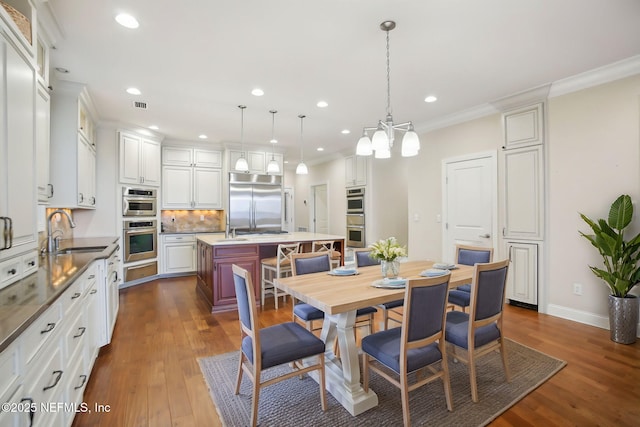 dining room featuring dark wood-type flooring, recessed lighting, visible vents, and crown molding