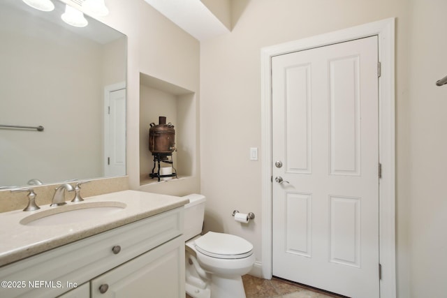 bathroom with toilet and vanity