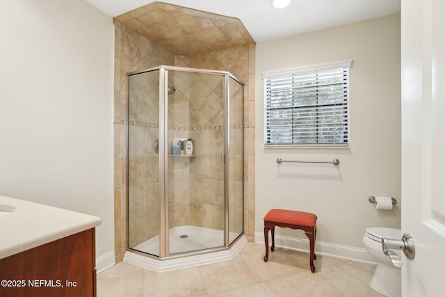 bathroom featuring a stall shower, baseboards, toilet, tile patterned flooring, and vanity