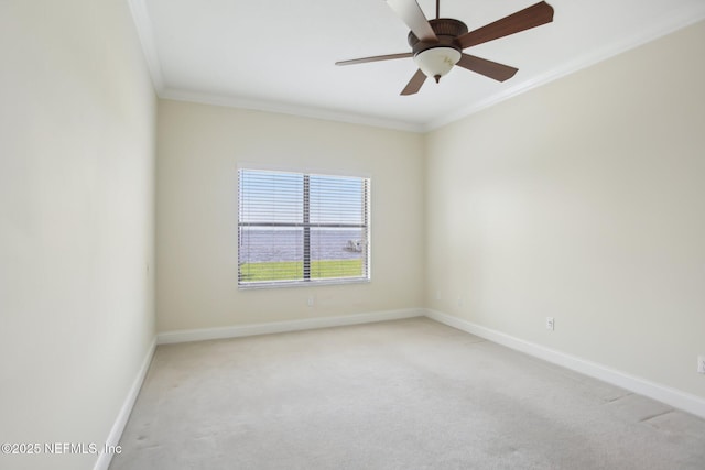 unfurnished room with baseboards, ceiling fan, ornamental molding, and light colored carpet