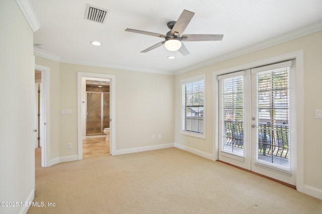 empty room featuring light carpet, baseboards, visible vents, and ornamental molding