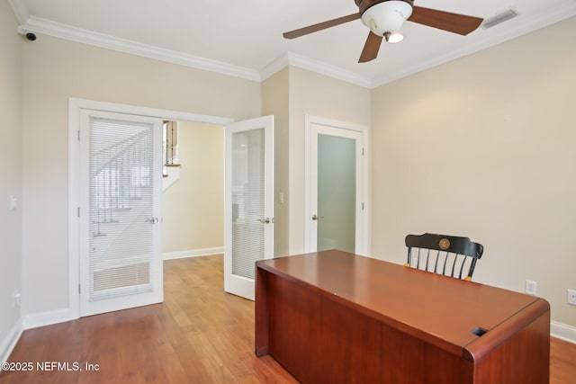 office space with ornamental molding, light wood-style flooring, and baseboards