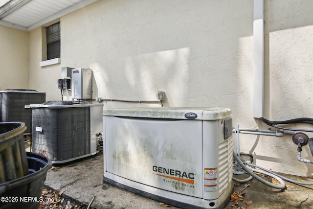 exterior details with a power unit, central AC, and stucco siding