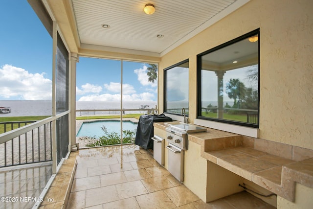 sunroom / solarium with a water view