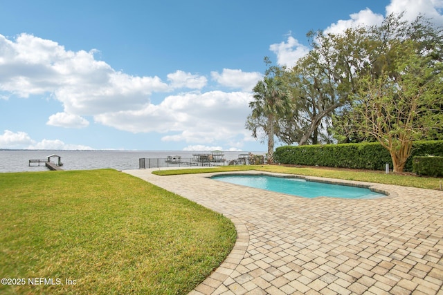 view of pool featuring fence, a yard, a boat dock, a fenced in pool, and a patio area