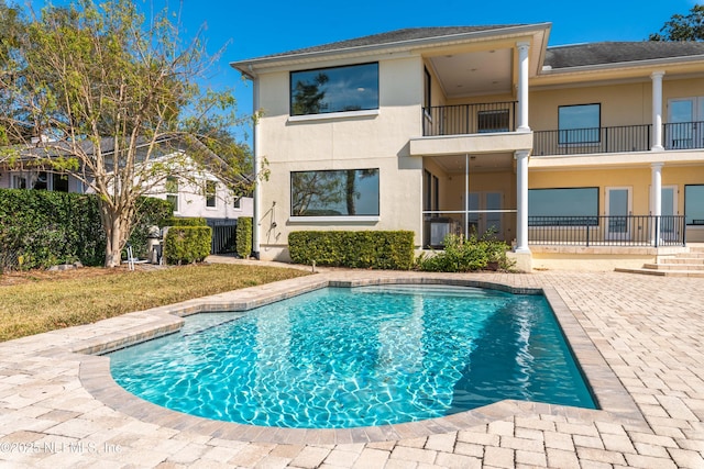 outdoor pool with a patio area