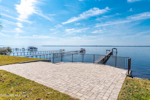 view of property's community featuring a water view and a dock