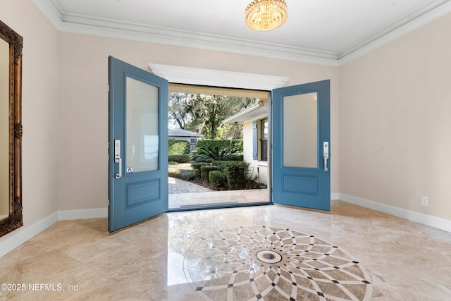 entrance foyer with marble finish floor, ornamental molding, and baseboards