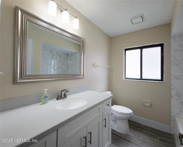 bathroom with toilet, vanity, baseboards, wood tiled floor, and walk in shower