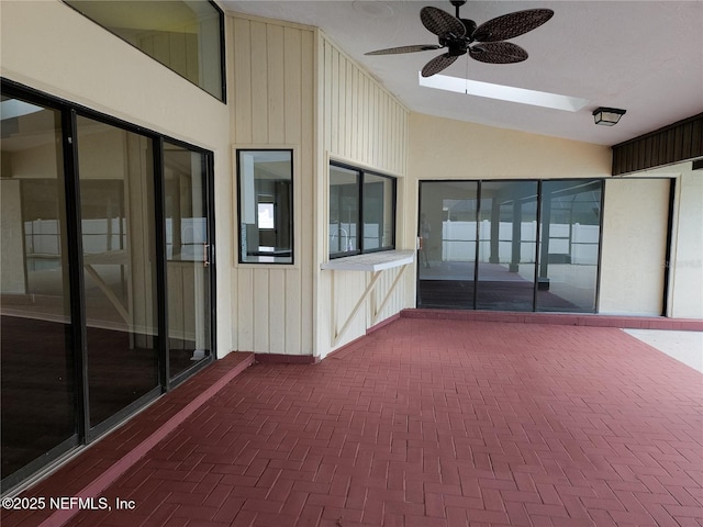 interior space with ceiling fan