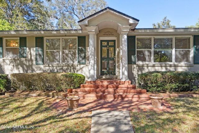 property entrance with stucco siding