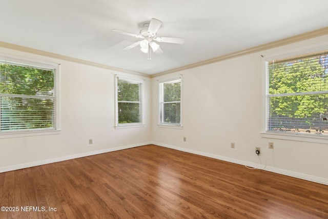 unfurnished room featuring ceiling fan, crown molding, baseboards, and wood finished floors