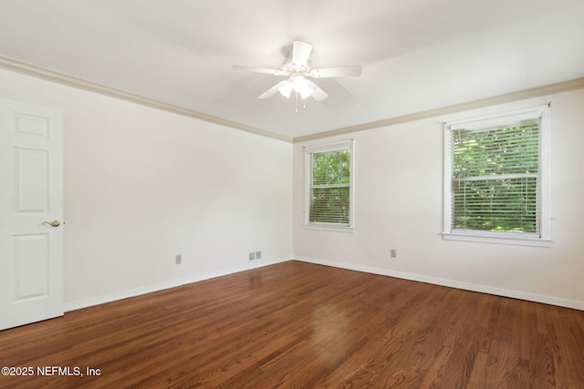 empty room with ceiling fan, crown molding, baseboards, and wood finished floors