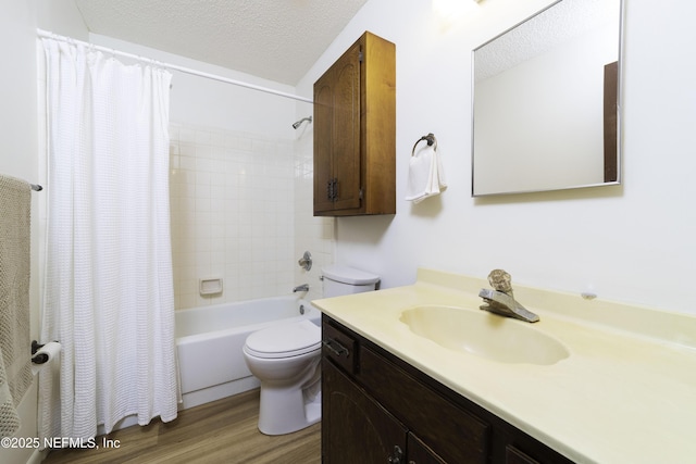 bathroom with vanity, wood finished floors, shower / bath combo with shower curtain, a textured ceiling, and toilet