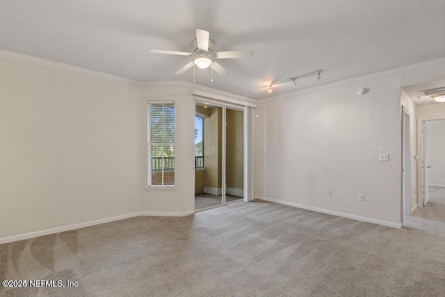 unfurnished room with carpet floors, ornamental molding, a ceiling fan, and baseboards