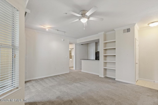 unfurnished bedroom featuring ornamental molding, carpet, visible vents, and baseboards