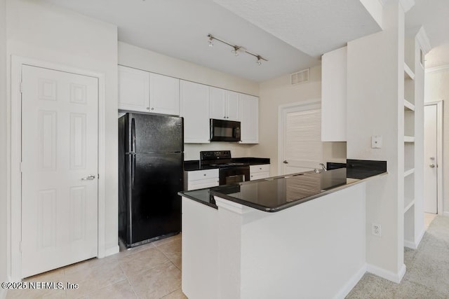 kitchen with light tile patterned flooring, visible vents, white cabinets, black appliances, and dark countertops