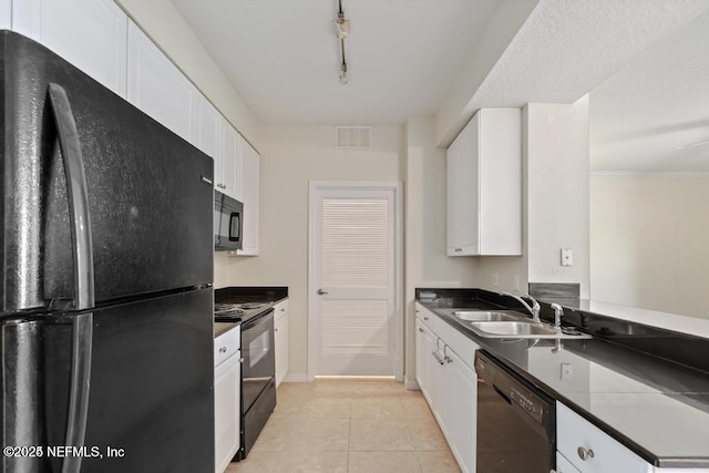 kitchen featuring light tile patterned floors, a sink, white cabinets, black appliances, and dark countertops