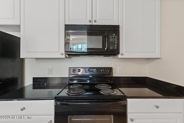 kitchen featuring black appliances, dark countertops, and white cabinets