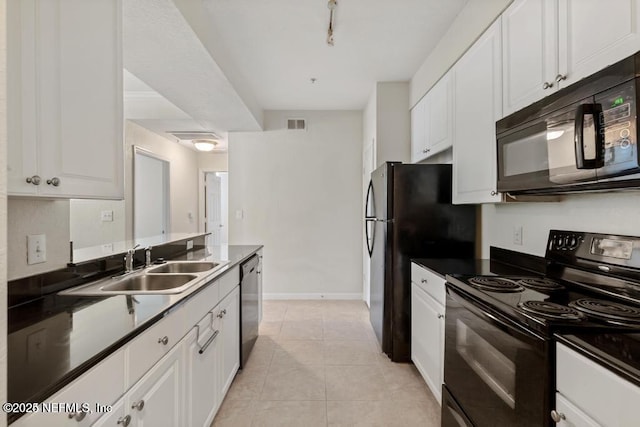 kitchen featuring black appliances, light tile patterned floors, white cabinetry, and a sink