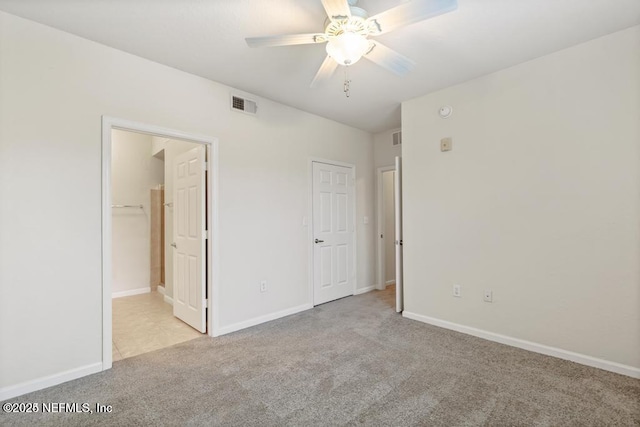 unfurnished bedroom with carpet floors, baseboards, and visible vents