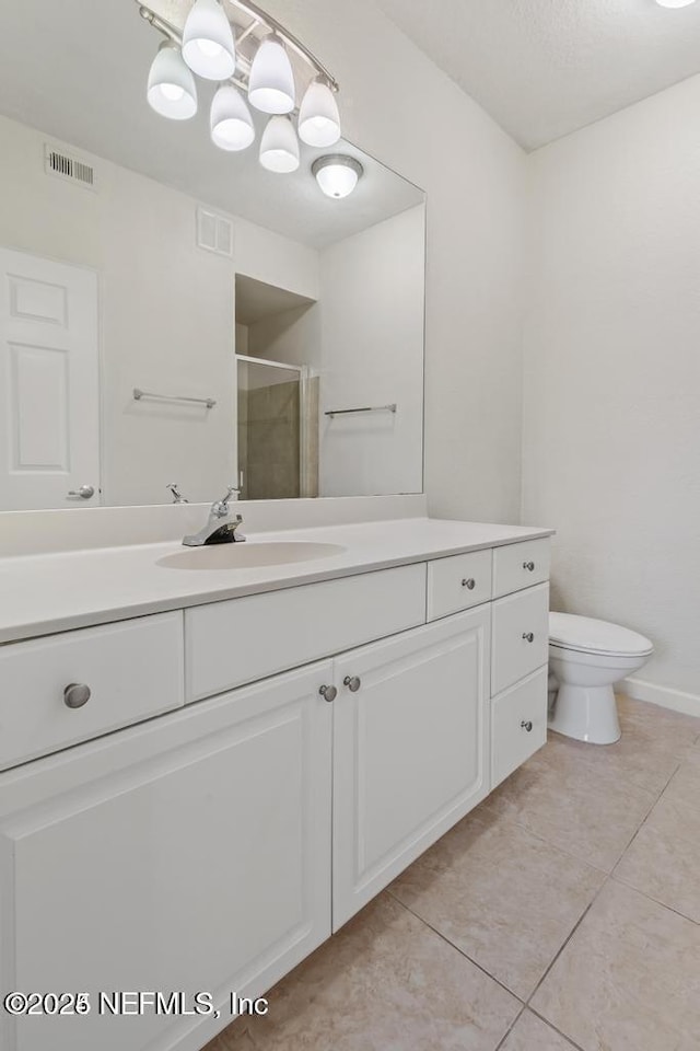 bathroom with a stall shower, visible vents, toilet, tile patterned floors, and vanity