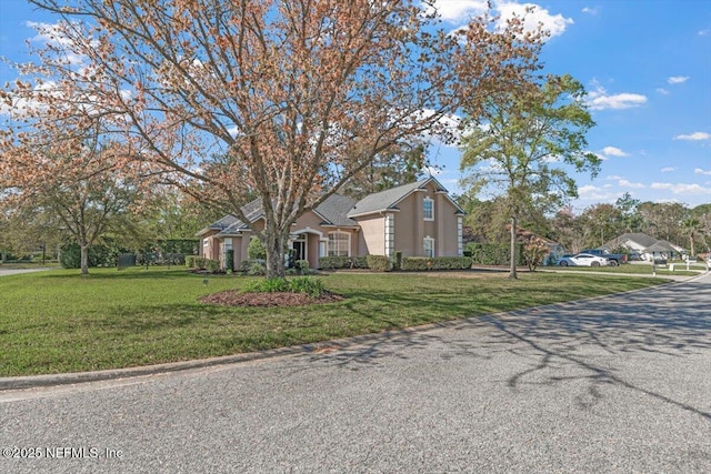 view of front of house with a front lawn and stucco siding