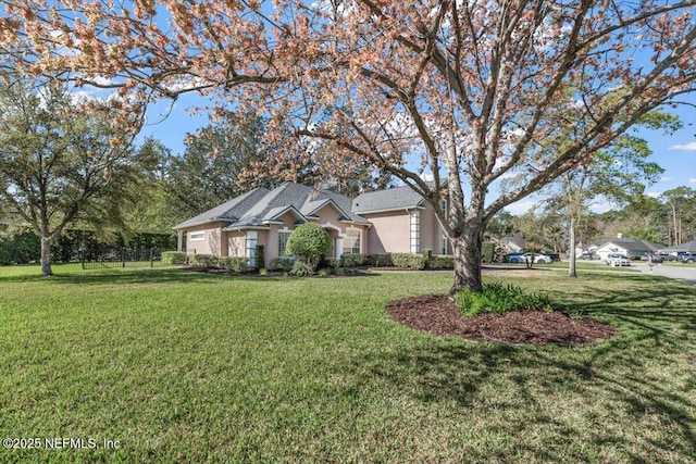 view of front of home featuring a front yard and stucco siding