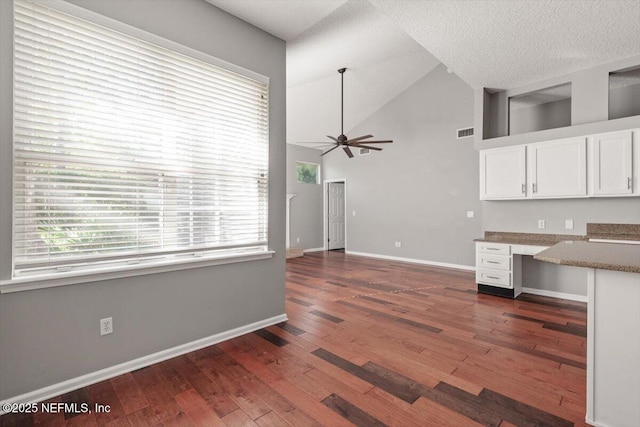 kitchen featuring visible vents, white cabinetry, built in study area, hardwood / wood-style floors, and plenty of natural light