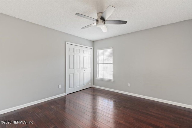 unfurnished bedroom with a textured ceiling, wood finished floors, a ceiling fan, baseboards, and a closet