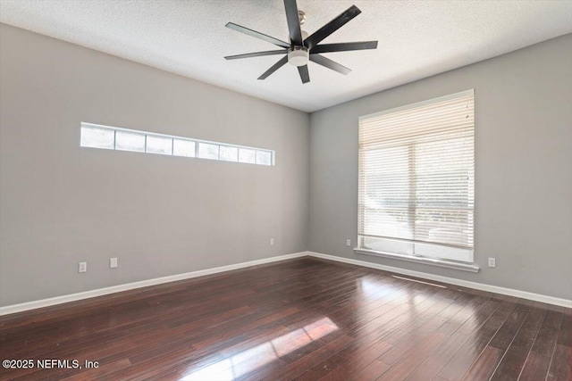 empty room featuring a ceiling fan, a textured ceiling, baseboards, and wood finished floors