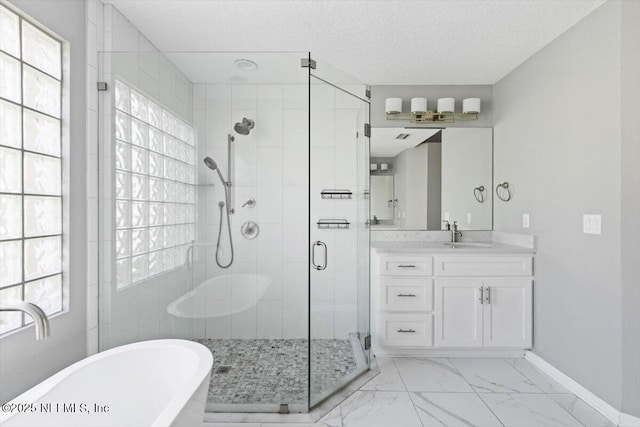 full bathroom featuring vanity, baseboards, marble finish floor, a soaking tub, and a stall shower