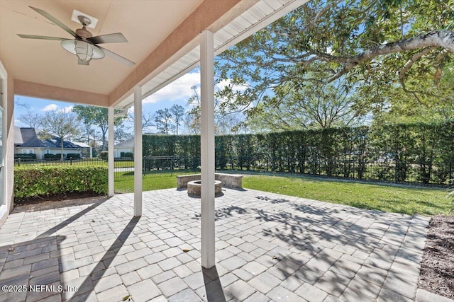 view of patio / terrace featuring ceiling fan, an outdoor fire pit, and a fenced backyard