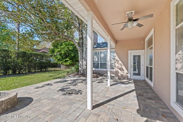 view of patio with ceiling fan and fence