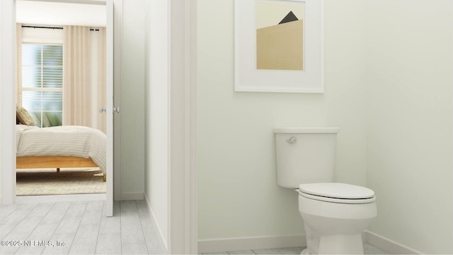 92 Hogan Ct, Saint Augustine, FL 32092 - bathroom with toilet, baseboards, and connected bathroom