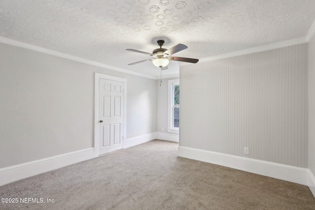 unfurnished room featuring ornamental molding, carpet, ceiling fan, and a textured ceiling