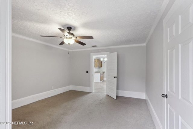 unfurnished bedroom with a textured ceiling, carpet flooring, visible vents, baseboards, and crown molding