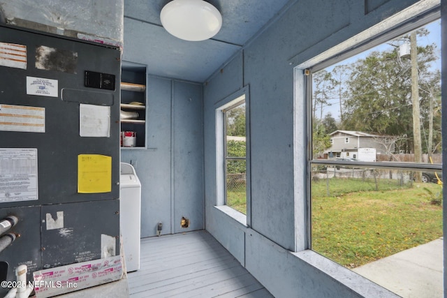 interior space with hardwood / wood-style floors, washer / dryer, and heating unit