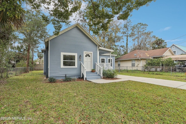 bungalow-style house with a front yard, concrete driveway, and fence private yard