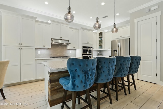 294 Mahi Dr, Ponte Vedra, FL 32081 - kitchen featuring tasteful backsplash, visible vents, ornamental molding, under cabinet range hood, and stainless steel appliances