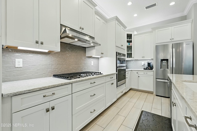 294 Mahi Dr, Ponte Vedra, FL 32081 - kitchen with under cabinet range hood, visible vents, ornamental molding, and appliances with stainless steel finishes