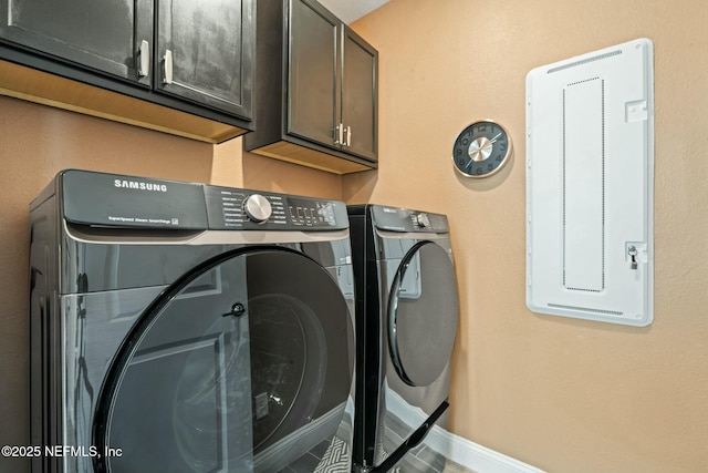 laundry room with washing machine and dryer, cabinet space, and baseboards