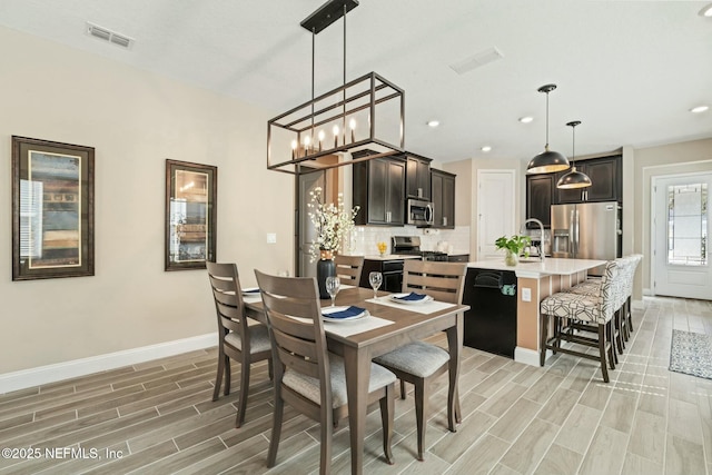 dining area with baseboards, recessed lighting, visible vents, and wood tiled floor