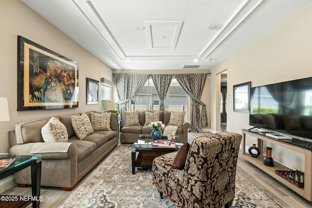 living room featuring wood finish floors and visible vents