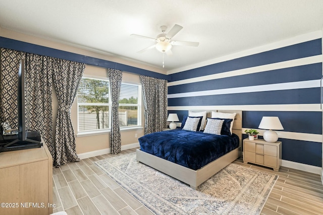 bedroom featuring baseboards, a ceiling fan, and wood tiled floor